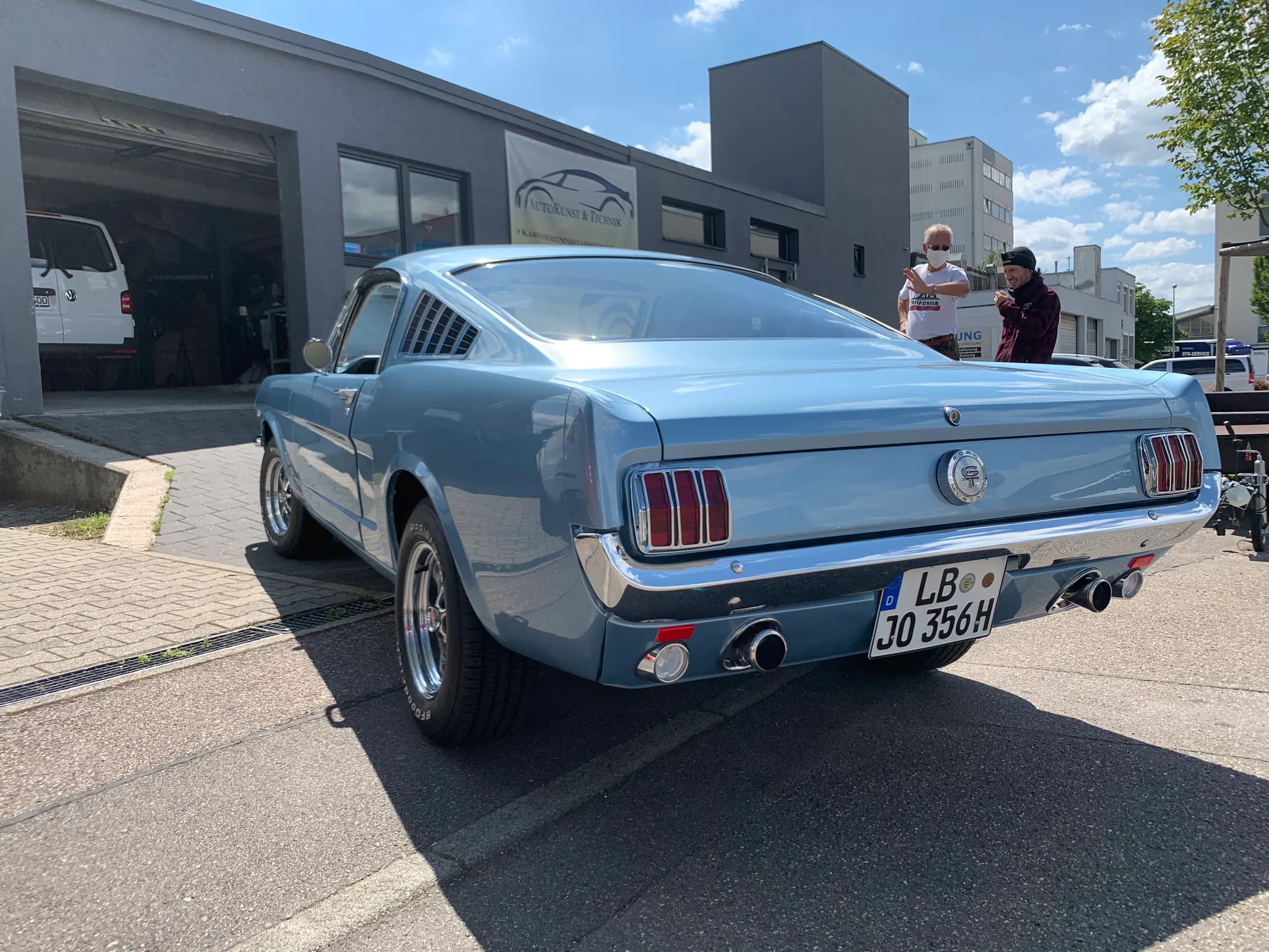 Hellblauer Ford Mustang Fastback von schräg hinten, fertig lackiert vor dem Betrieb, mit H-Kennzeichen.